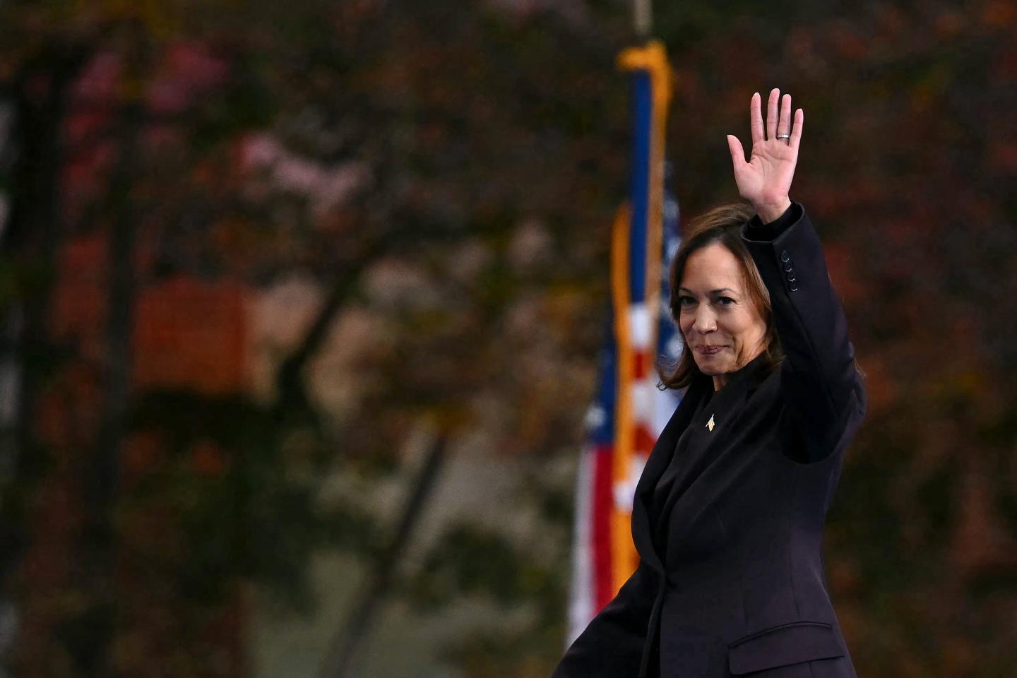 Vice President Kamala Harris waving at an audience of supporters