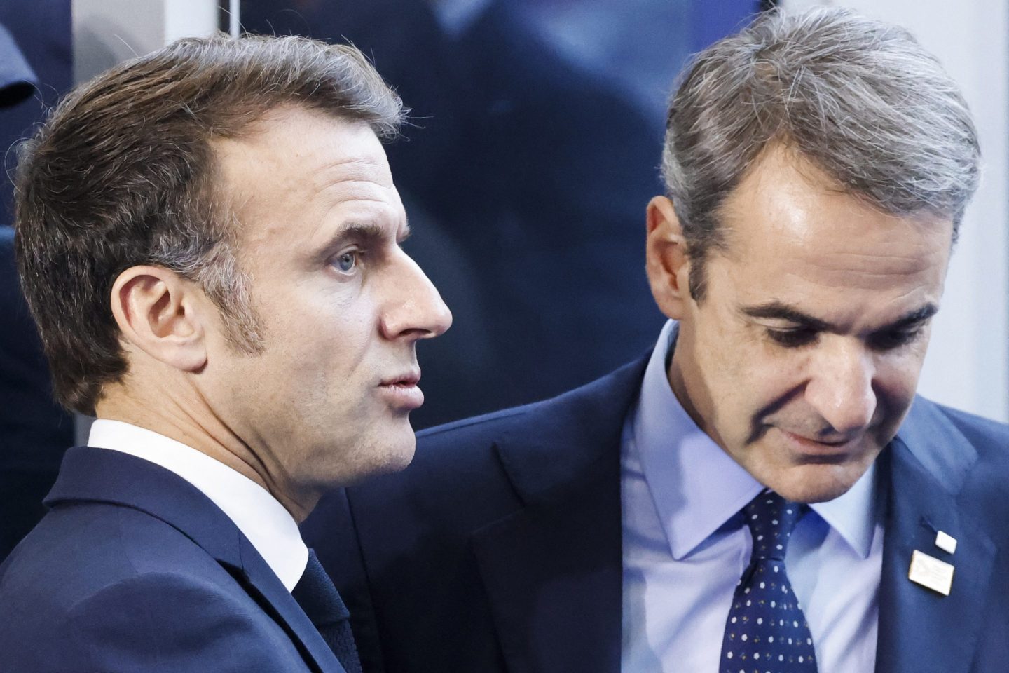 A side profile of Emmanuel Macron, left, next to Greece's prime minister