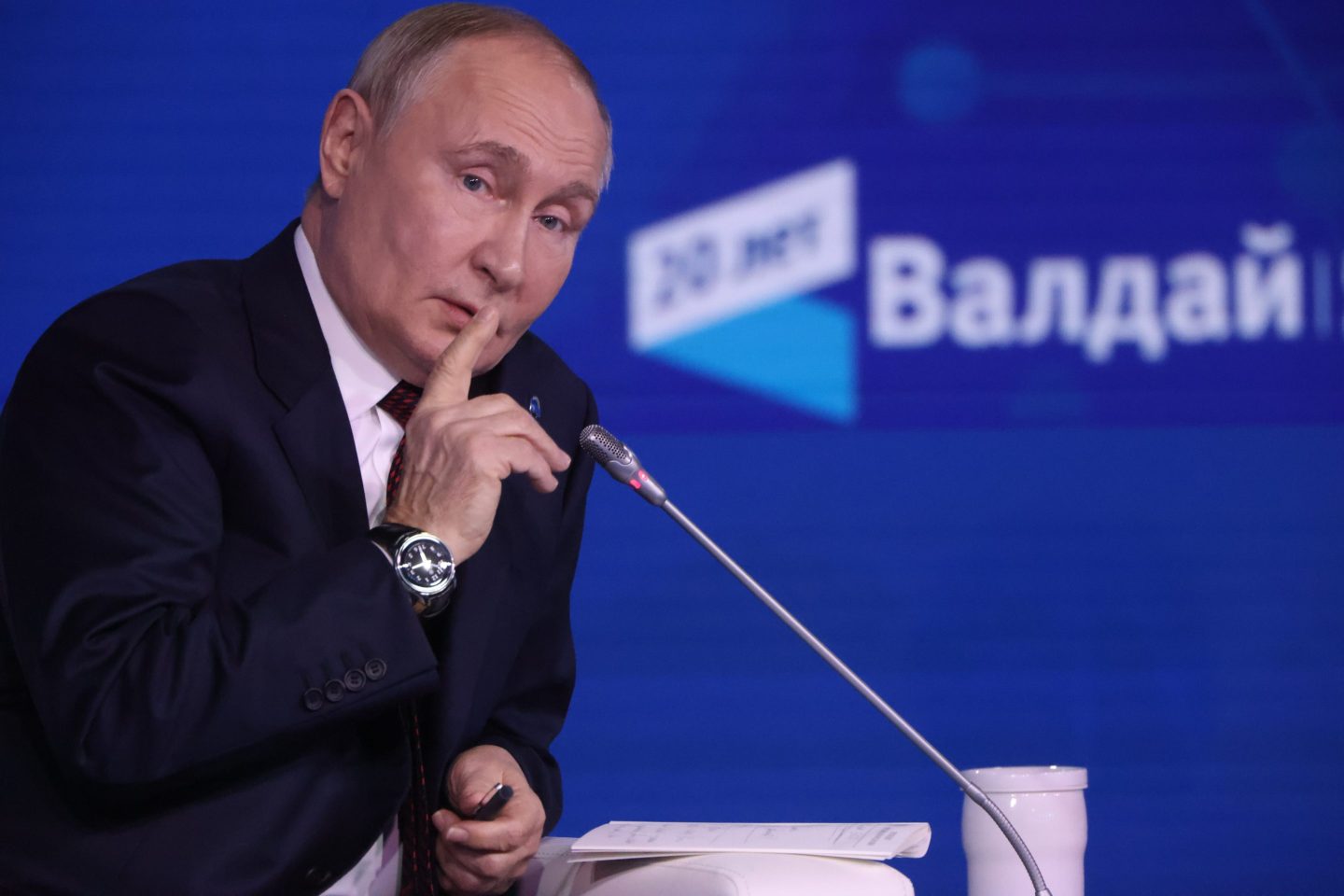 Russian President Vladimir Putin speaking at a mic.