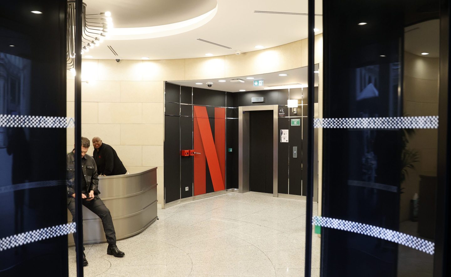 The Netflix logo is seen at the entrance to the headquarters of U.S. entertainment company Netflix on November 05, 2024 in Paris, France. The French publication Marianne reported that Netflix offices in Paris and Amsterdam were searched on Tuesday morning by investigators specializing in financial crime.