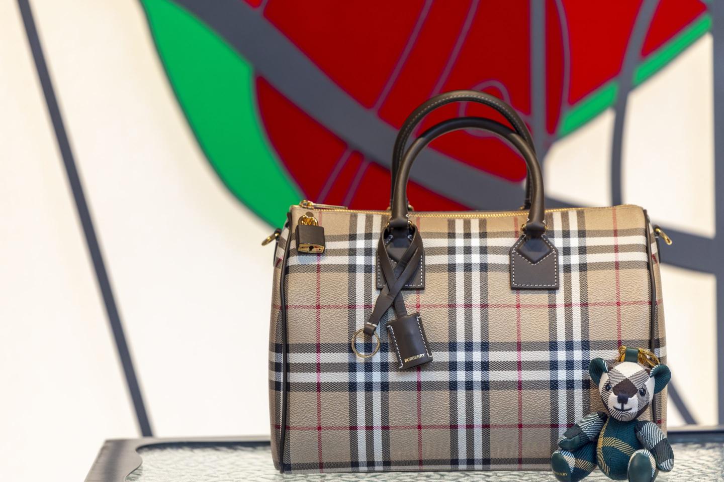 A luxury Burberry handbag sits, waiting to be plucked by a rich customer