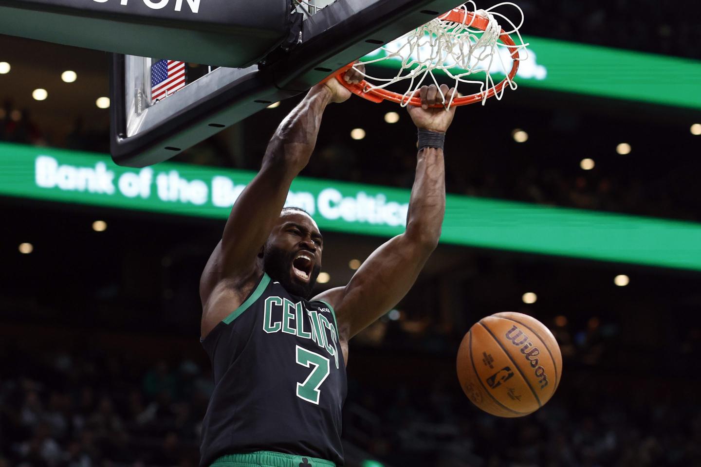 The Boston Celtics' Jaylen Brown dunks a basketball