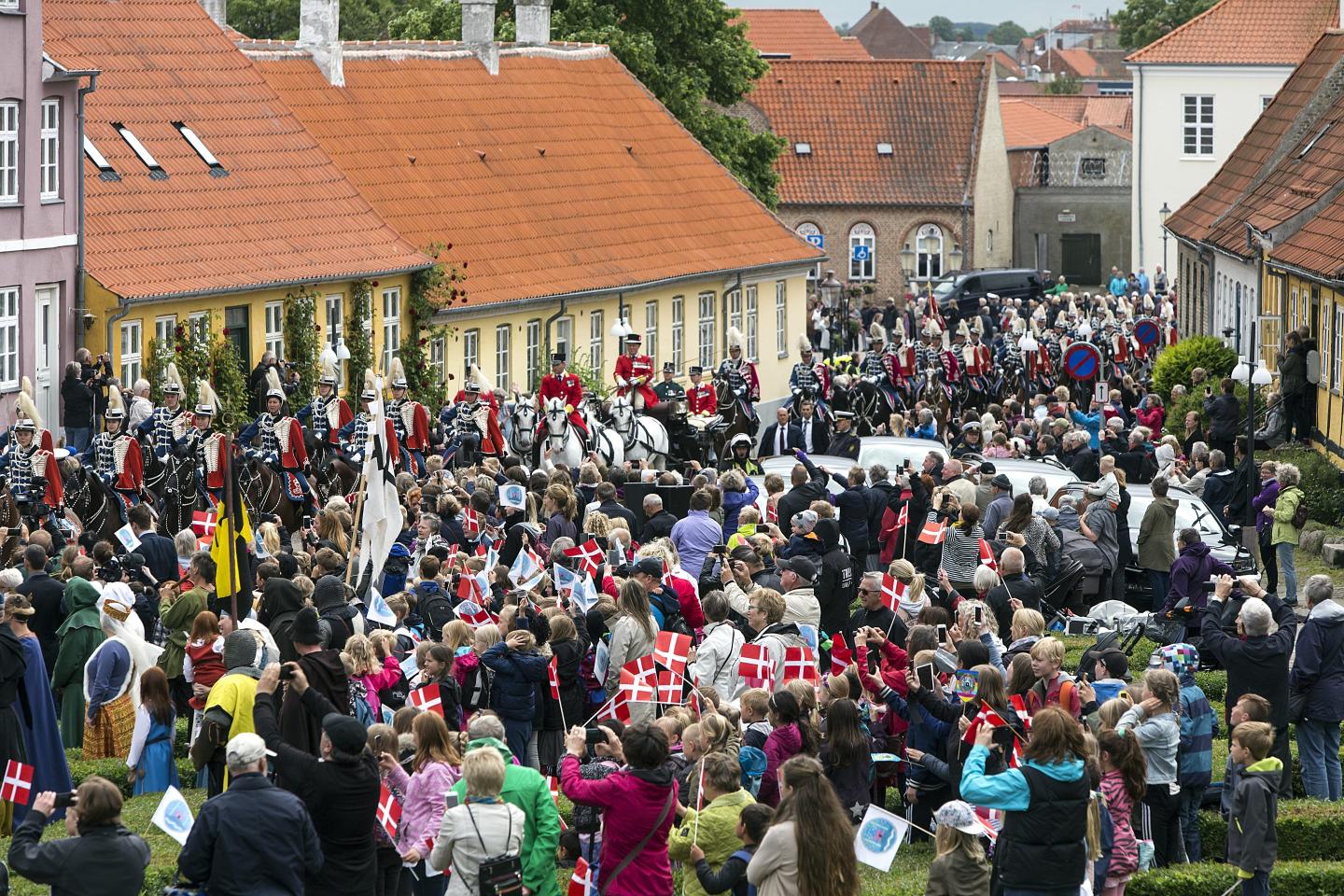 Many hundred of spectators watch Queen Margrethe of Denmark while the Royal Guard takes her through the city of Kalundborg in a coach during her visit to the city where she commence a two days visit on June 13, 2017 in Kalundborg, Denmark.