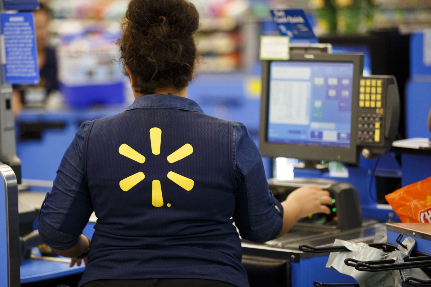 An employee scans items at a cash register at a Wal-Mart Stores Inc.