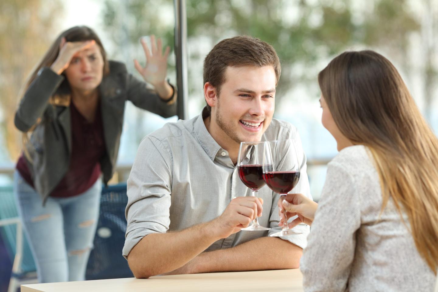 ex girlfriend spying to a couple dating drinking wine.