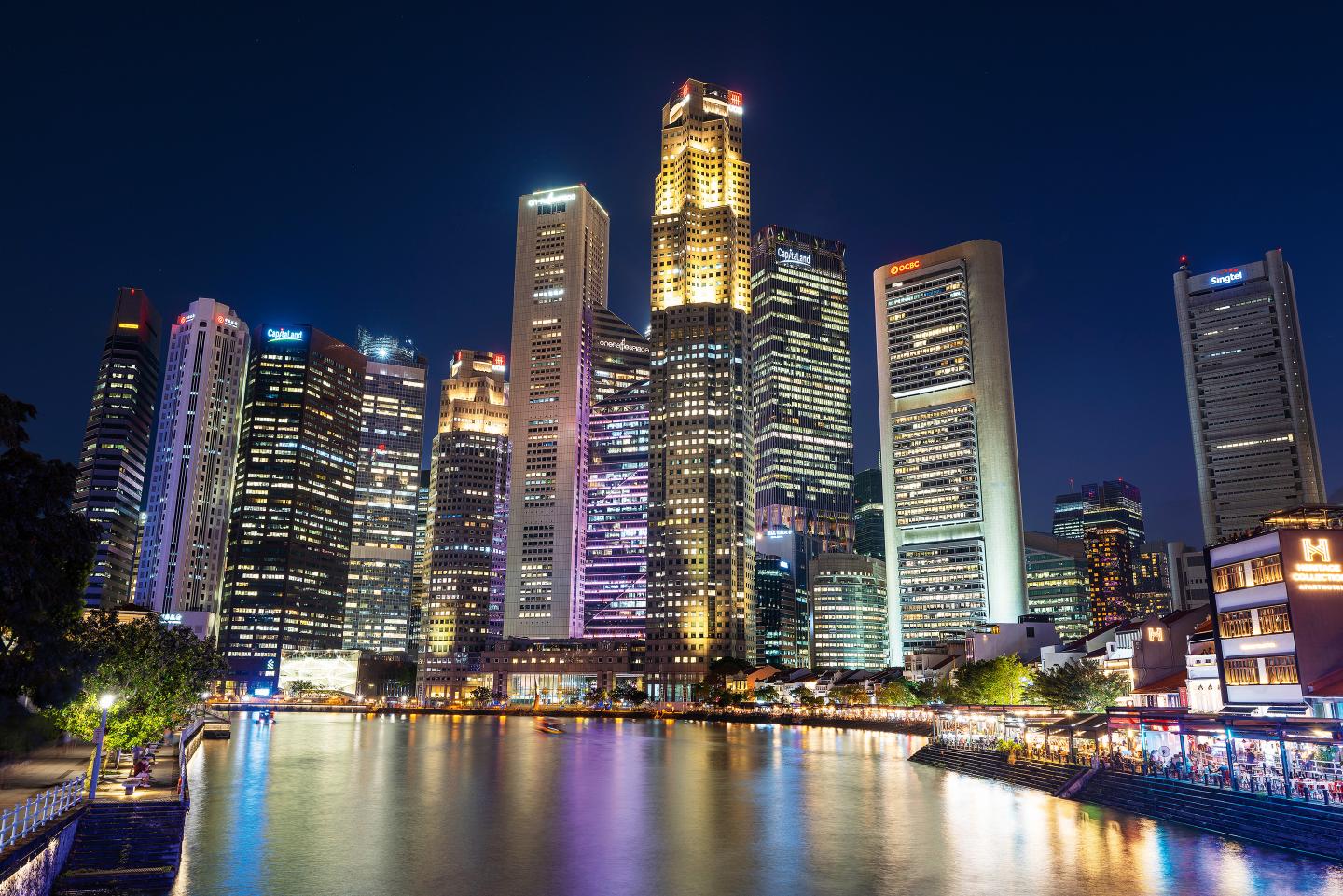 Where East meets West: A nighttime view of Singapore's financial district, with OCBC headquarters second from right. OCBC is poised to benefit from rising tensions between the U.S. and China.