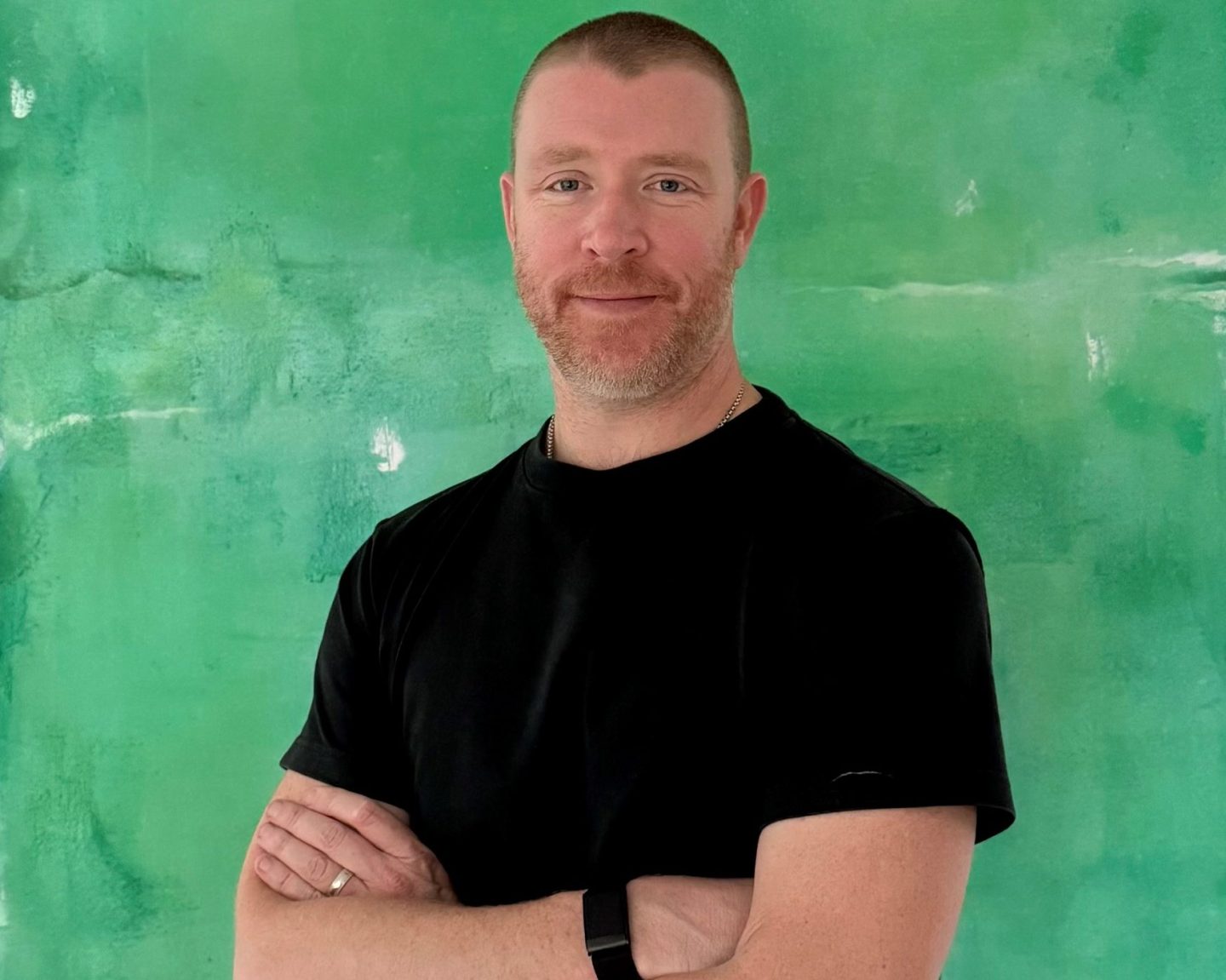 headshot of businessman with his arms crossed