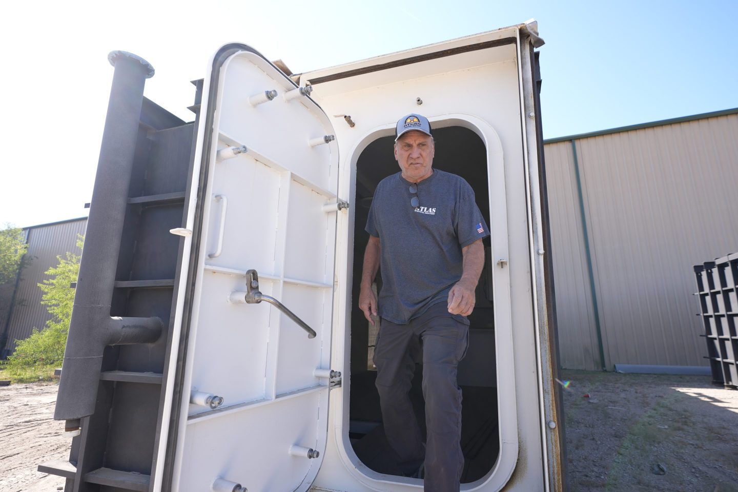 Ron Hubbard, owner of Atlas Survival Shelters, walks out the door of a bunker his company is building for a client during a tour of his operations in Sulphur Springs, Texas, on Aug. 27, 2024,