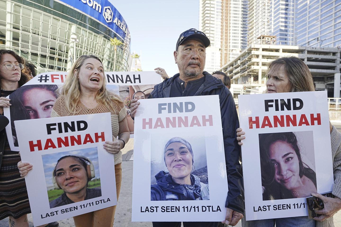 Ryan Kobayashi, center, holds a picture of his missing daughter Hannah Kobayashi