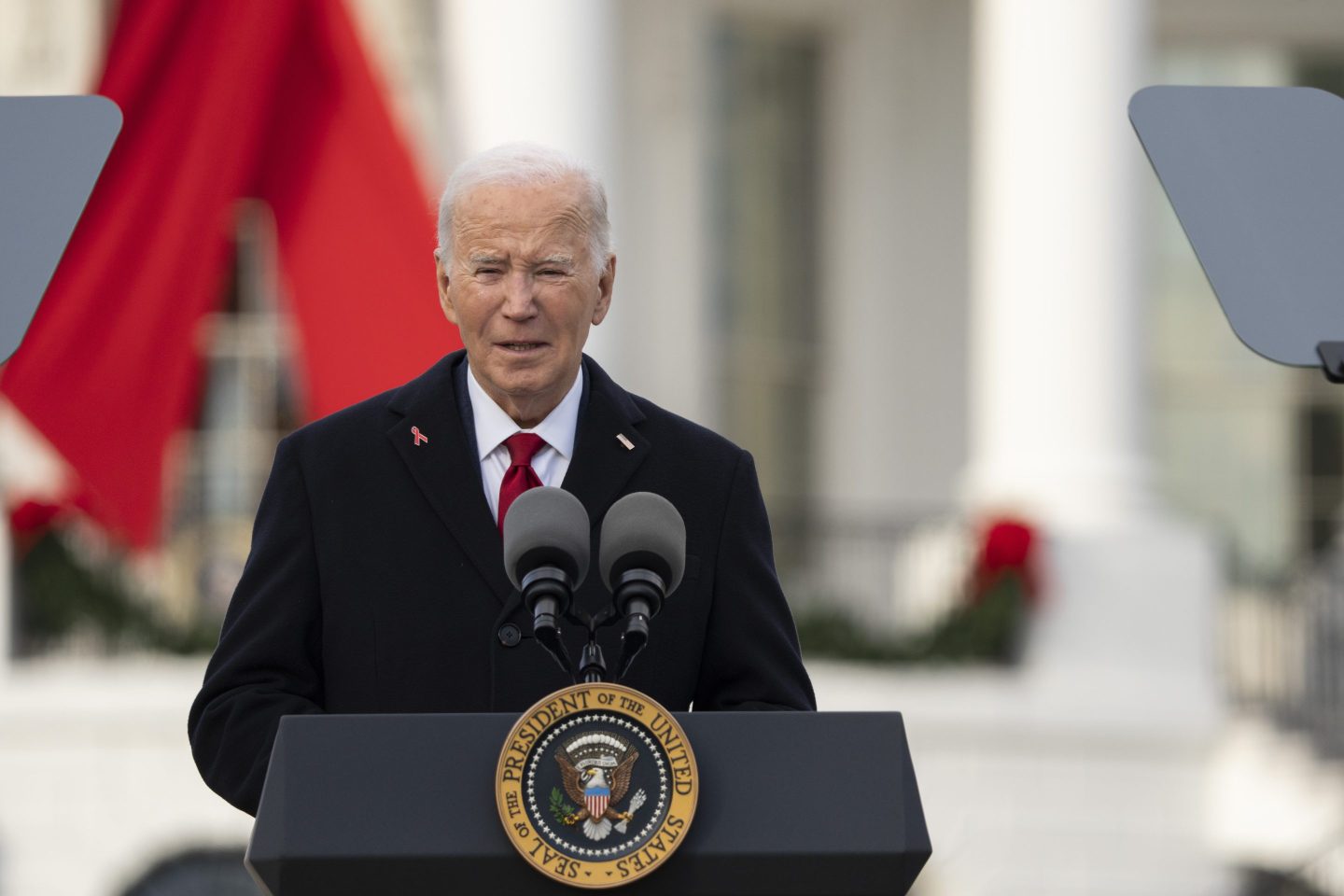 President Joe Biden speaks on the South Lawn of the White House during a ceremony to commemorate World AIDS Day with survivors, their families and advocates, on Dec. 1, 2024, in Washington.