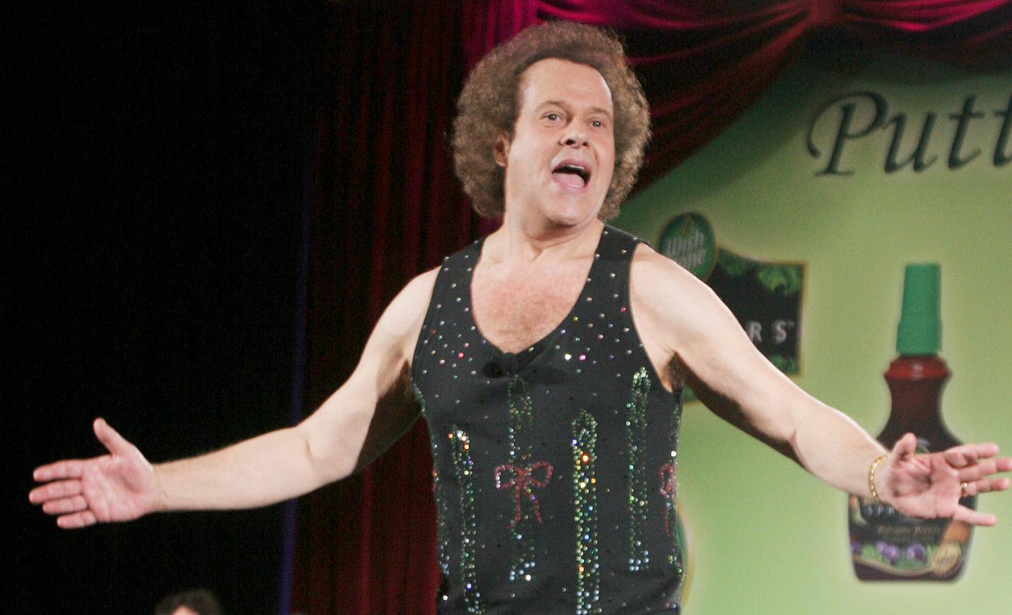  In this June 2, 2006, file photo, Richard Simmons speaks to the audience before the start of a summer salad fashion show at Grand Central Terminal in New York.
