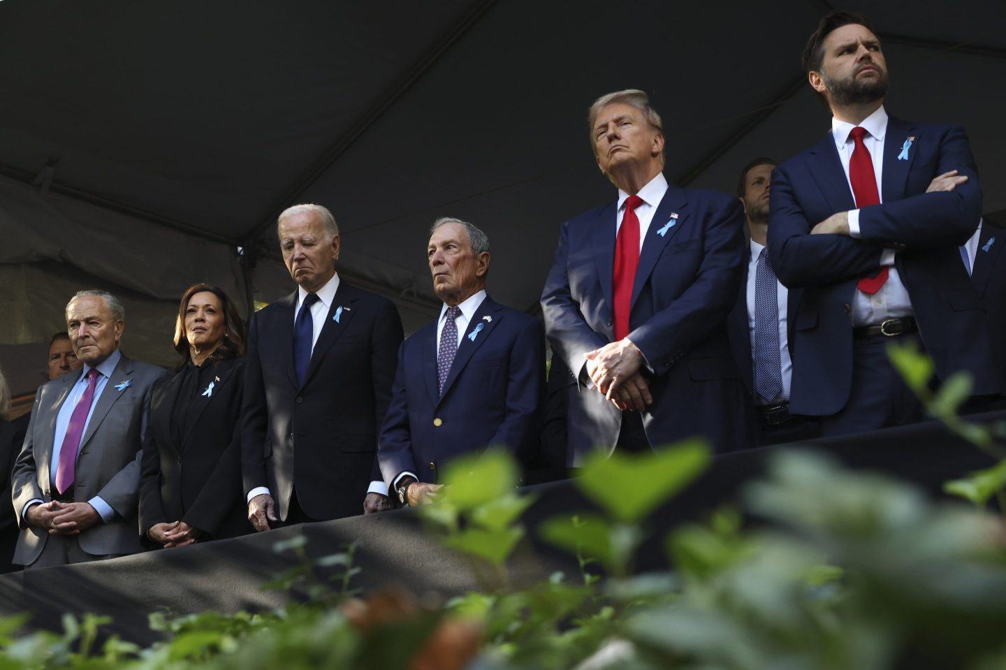 From left, Sen. Chuck Schumer, D-NY, Democratic presidential nominee Vice President Kamala Harris, President Joe Biden, Michael Bloomberg, Republican presidential nominee former President Donald Trump and Republican vice presidential nominee Sen. JD Vance, R-Ohio, attend the 9/11 Memorial ceremony on the 23rd anniversary of the Sept. 11, 2001 attacks, on Sept. 11, 2024, in New York.