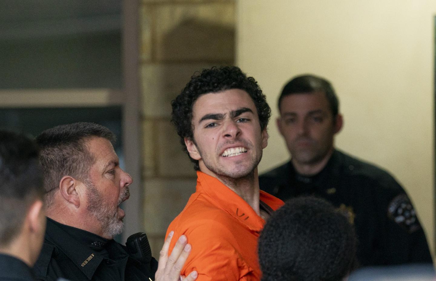 Accused UnitedHealthcare CEO killer Luigi Mangione shouts and struggles on way into courthouse—and fights extradition to New York