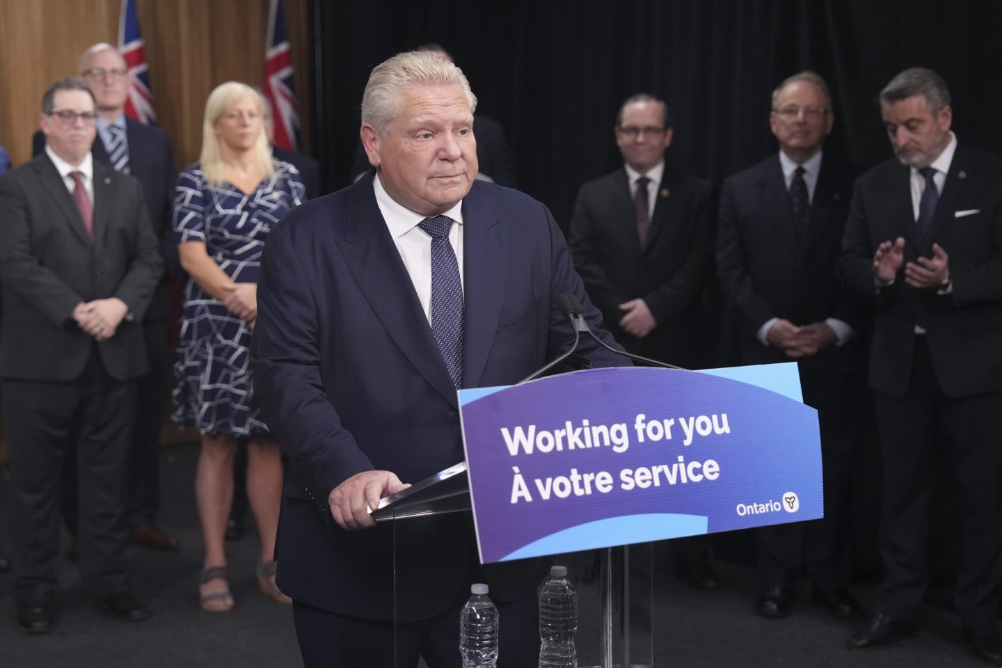 Ontario Premier Doug Ford speaks to members of the media as mayors from selected municipalities and government ministers look on the Queen's Park Legislature in Toronto on Dec. 12, 2024.