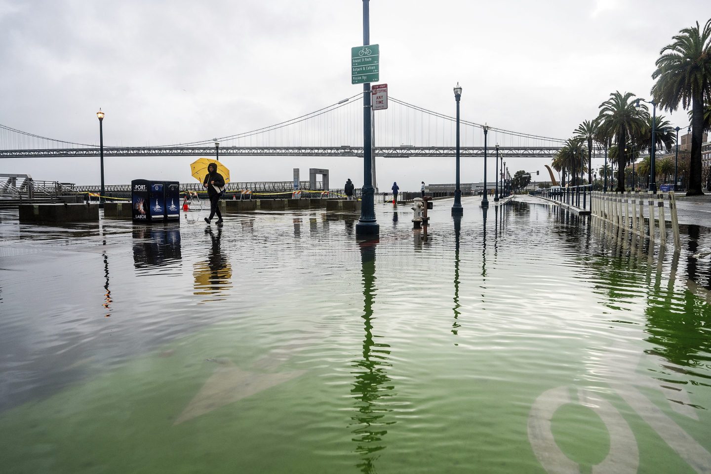 Water from the San Francisco Bay spills onto the Embarcadero as a result of high tides and storm-driven waves on Dec. 14, 2024, in San Francisco.