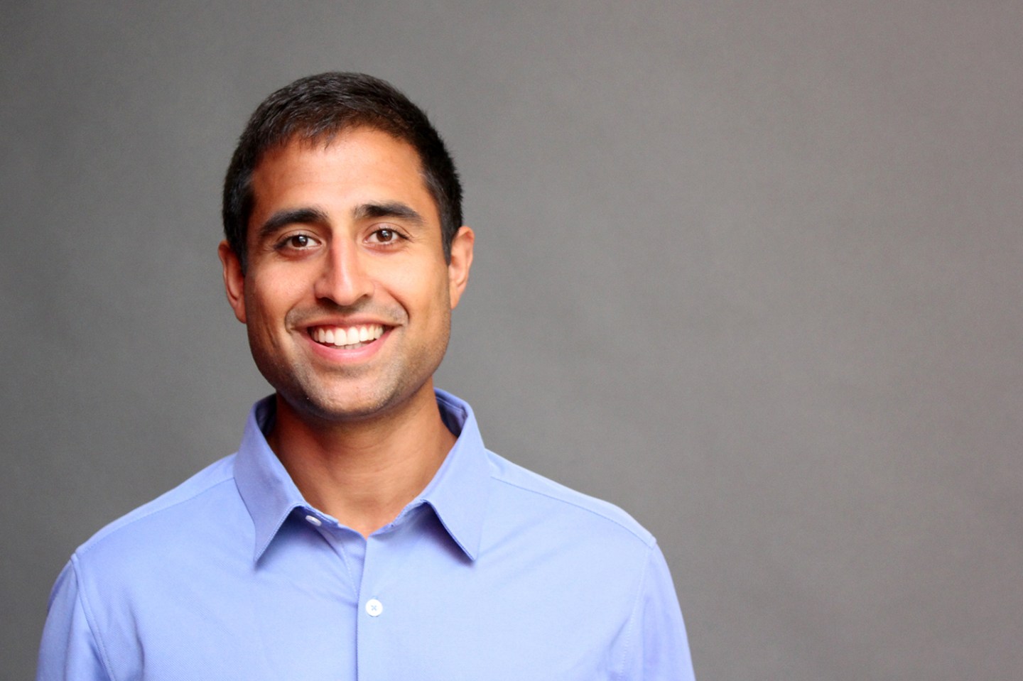aman advani wearing a collared shirt and smiling