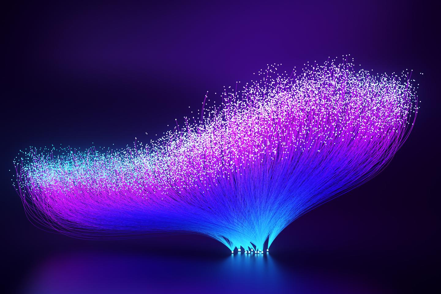 Digitally generated images of vibrant, abstract fiber optics radiating outwards into the abyss.