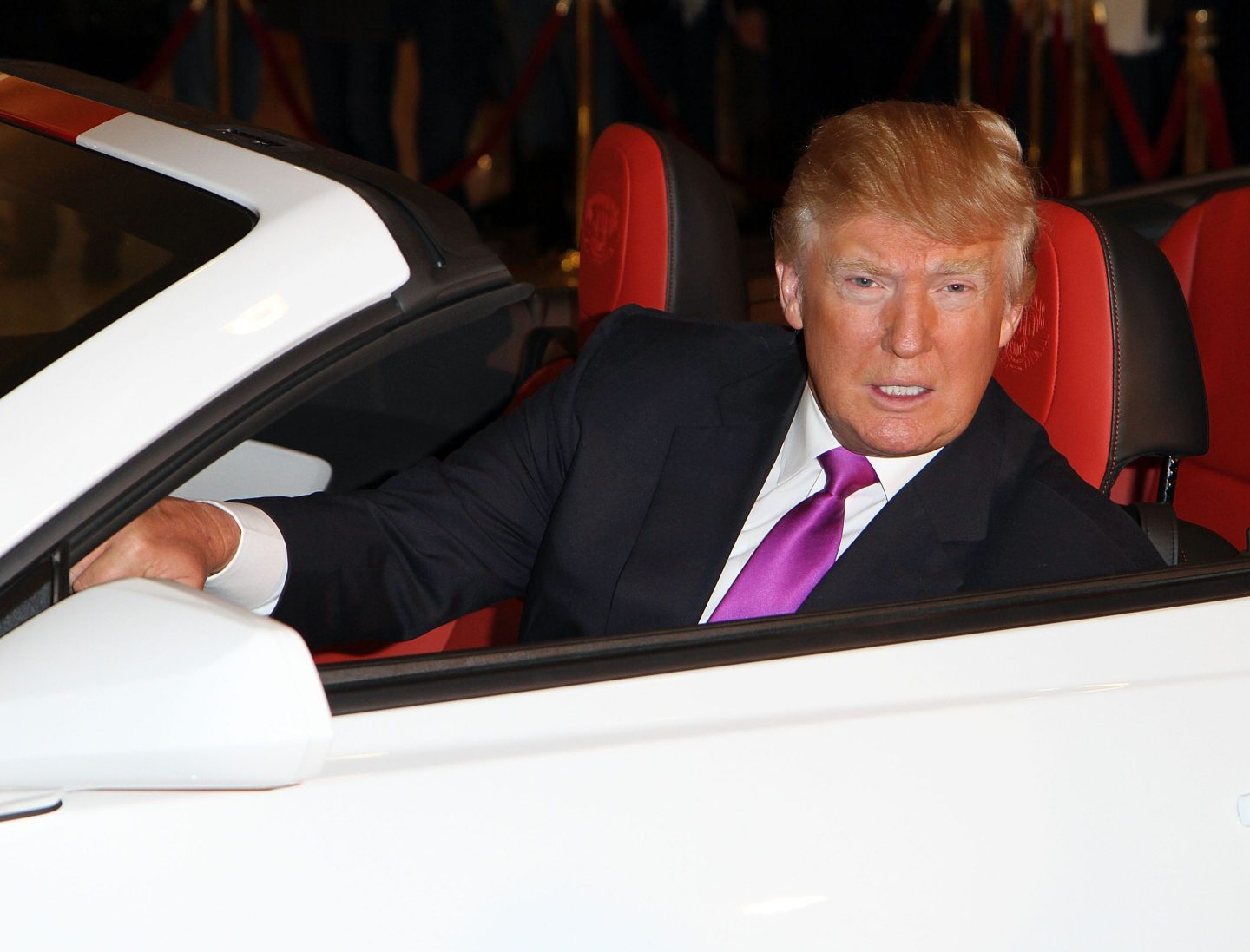 President-elect Donald Trump sitting behind the wheel of a white convertible