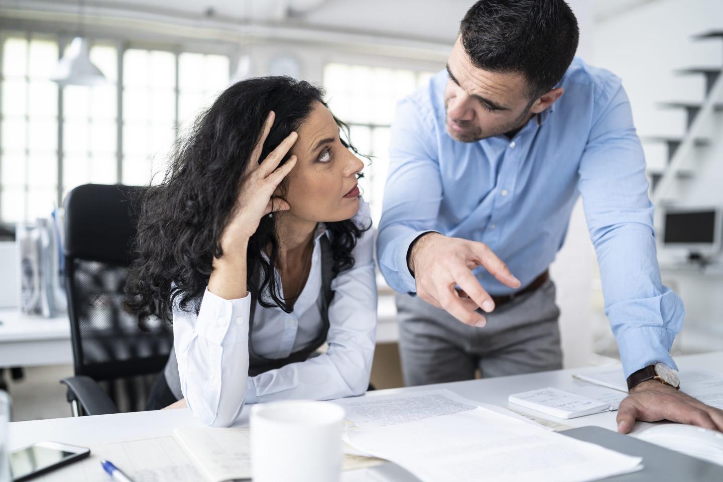 Coworkers sitting at workplace and discussing problems
