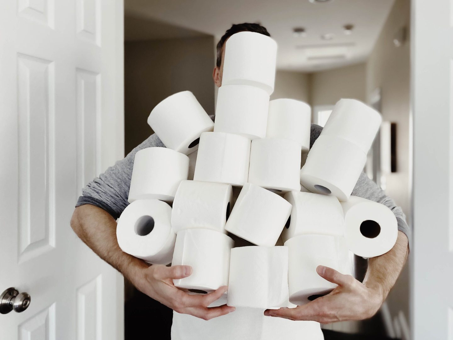 Man carrying rolls of toilet paper