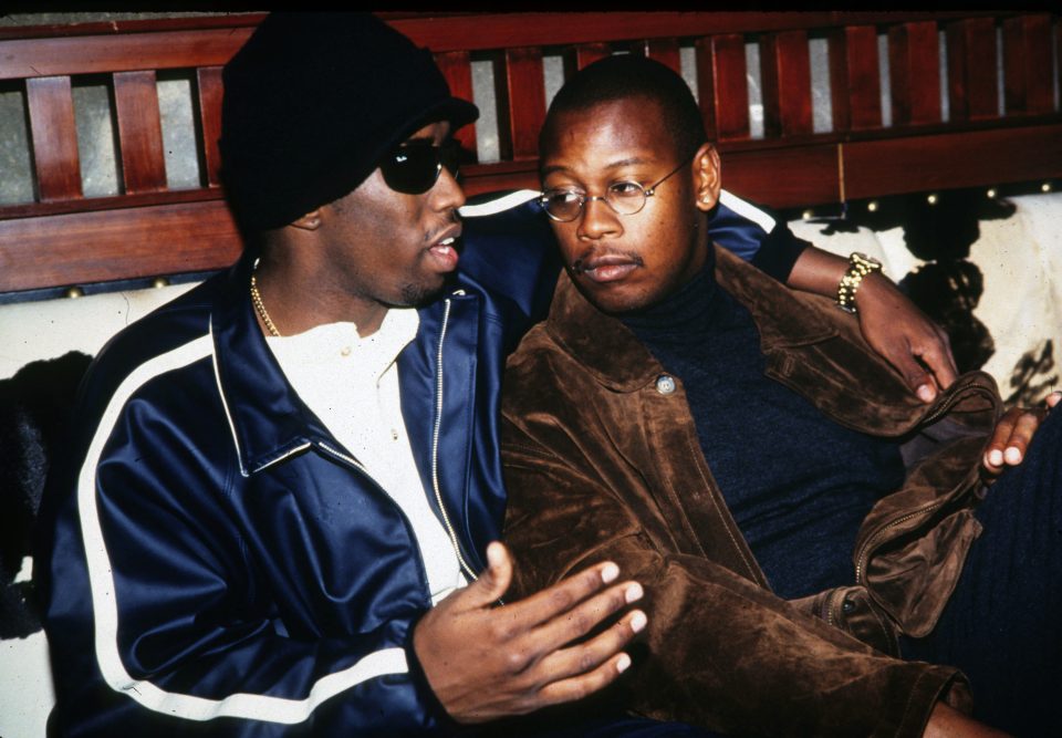 Uptown Records head Andre Harrell relaxes in a nightclub VIP area by chatting with Sean "Puffy" Combs on November 12, 1994