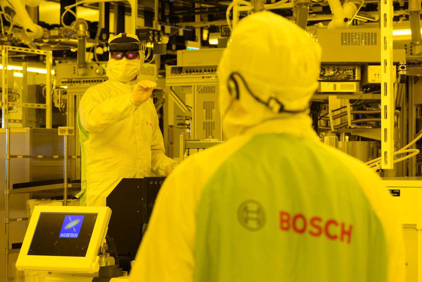 An associate demonstrates maintenance work on a testing machine for chips with augmented reality glasses, a computer-based enhancement of reality perception, during a press tour for "Bosch Tech Day" at Bosch's semiconductor factory.