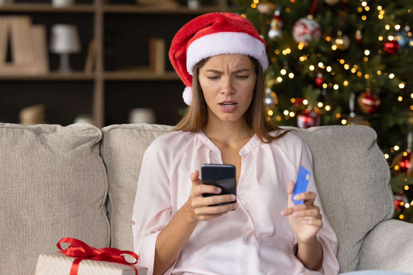 Worried concerned girl in Christmas Santa hat having problems