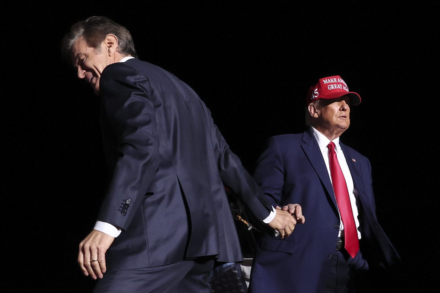 Dr. Mehmet Oz shakes hands with Donald Trump during a 2022 rally in Pennsylvania.