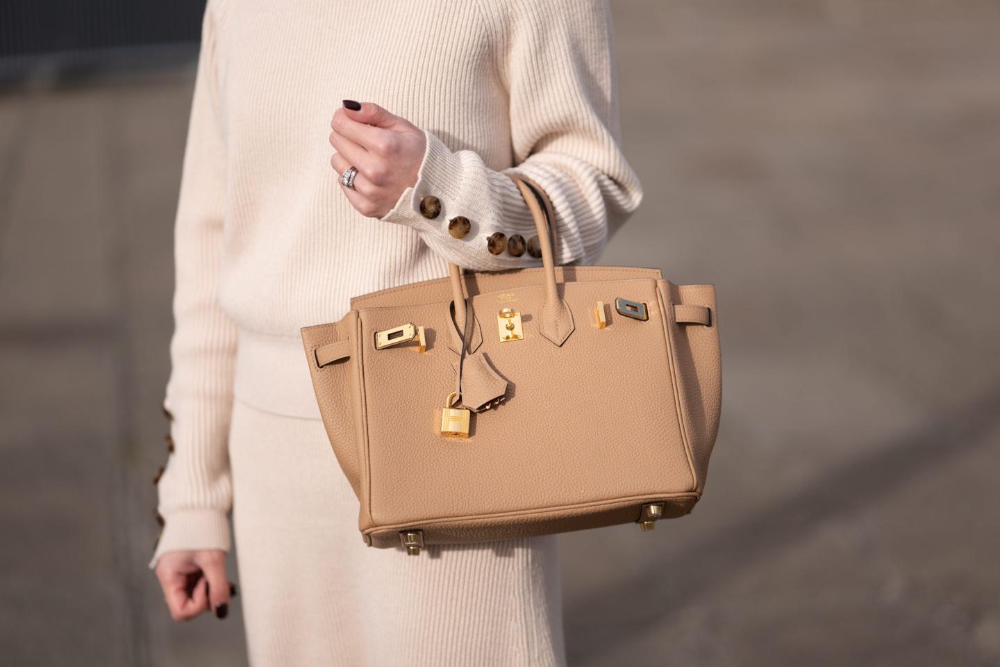 Woman carrying a genuine Birkin handbag