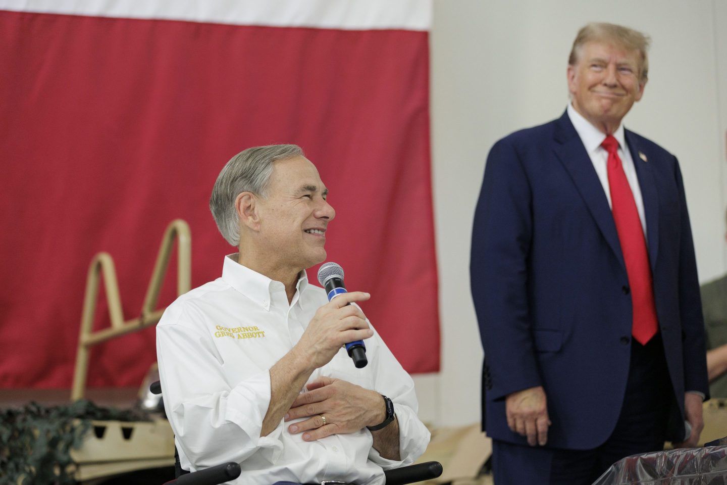 Texas Governor Greg Abbott gives remarks with Former President Donald Trump at the border.