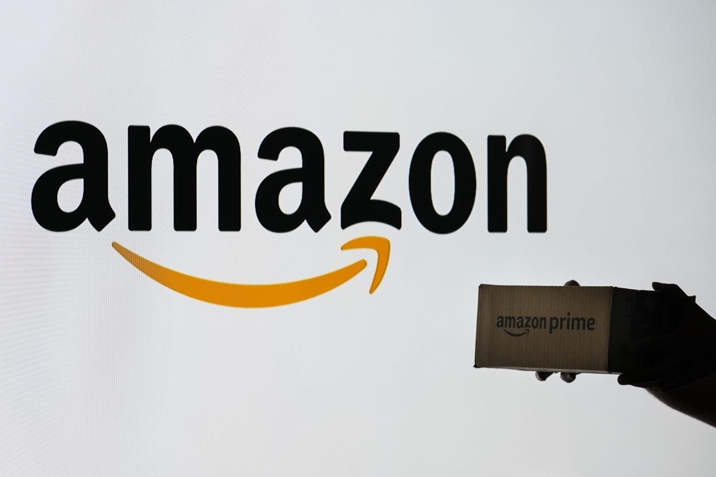 Amazon logo and hands holding a package