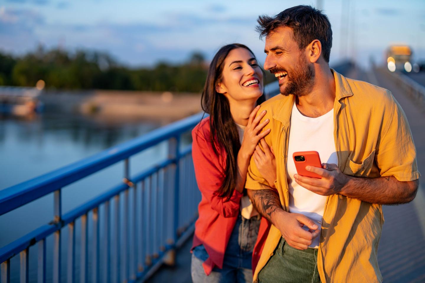 A joyful couple is captured laughing together