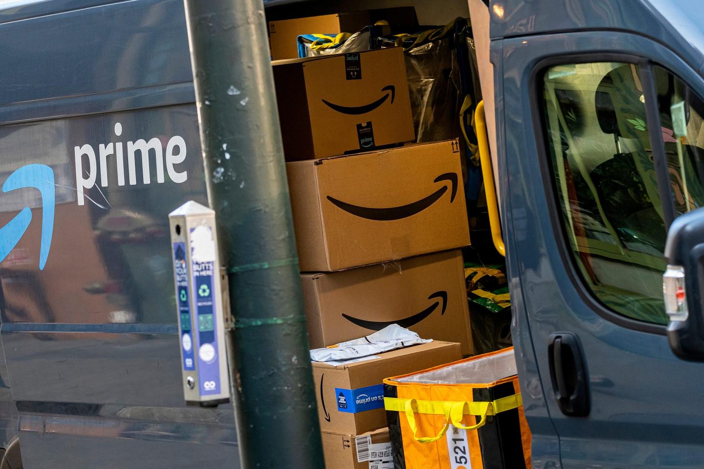 An Amazon delivery truck with its door open, revealing packages inside