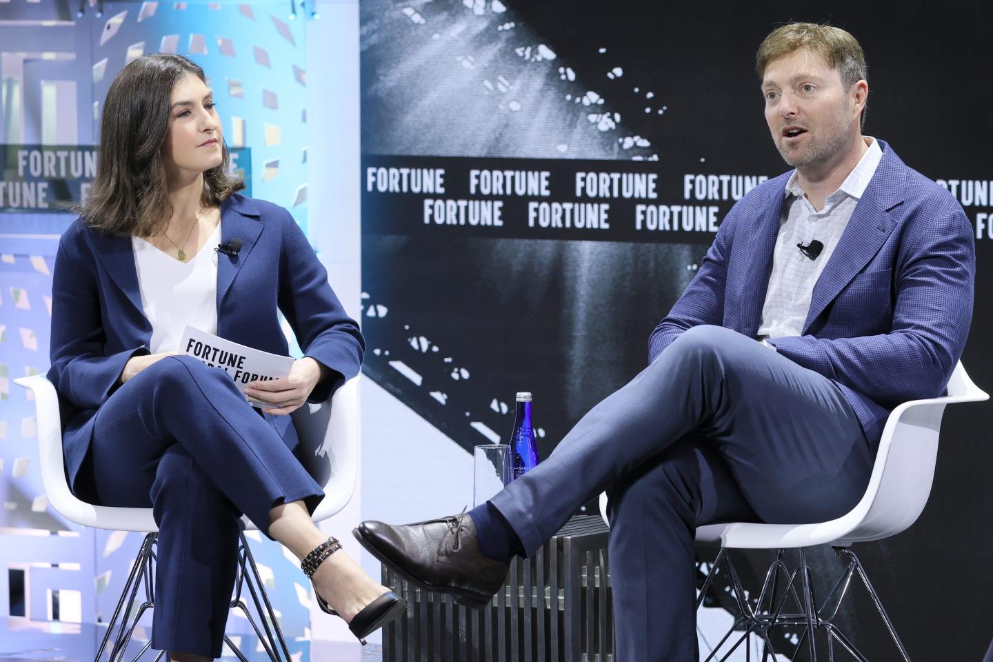 Alex Chriss sits and talks on stage with Fortune reporter Kristin Stoller.