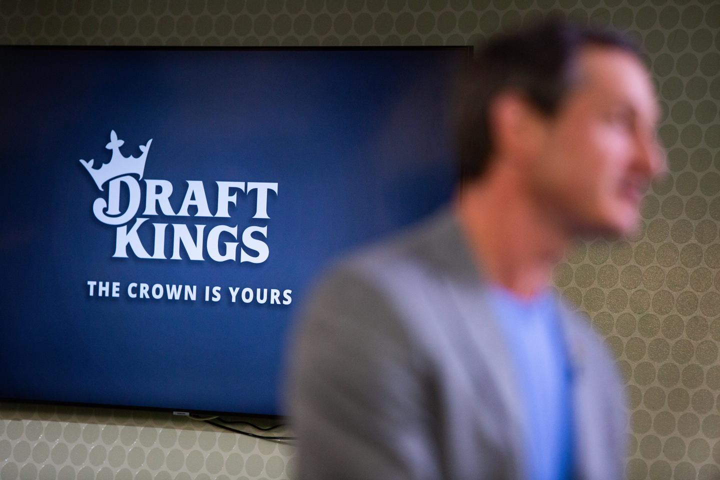 DraftKings signage as Jason Robins, co-founder and chief executive officer of DraftKings Inc., is interviewed.