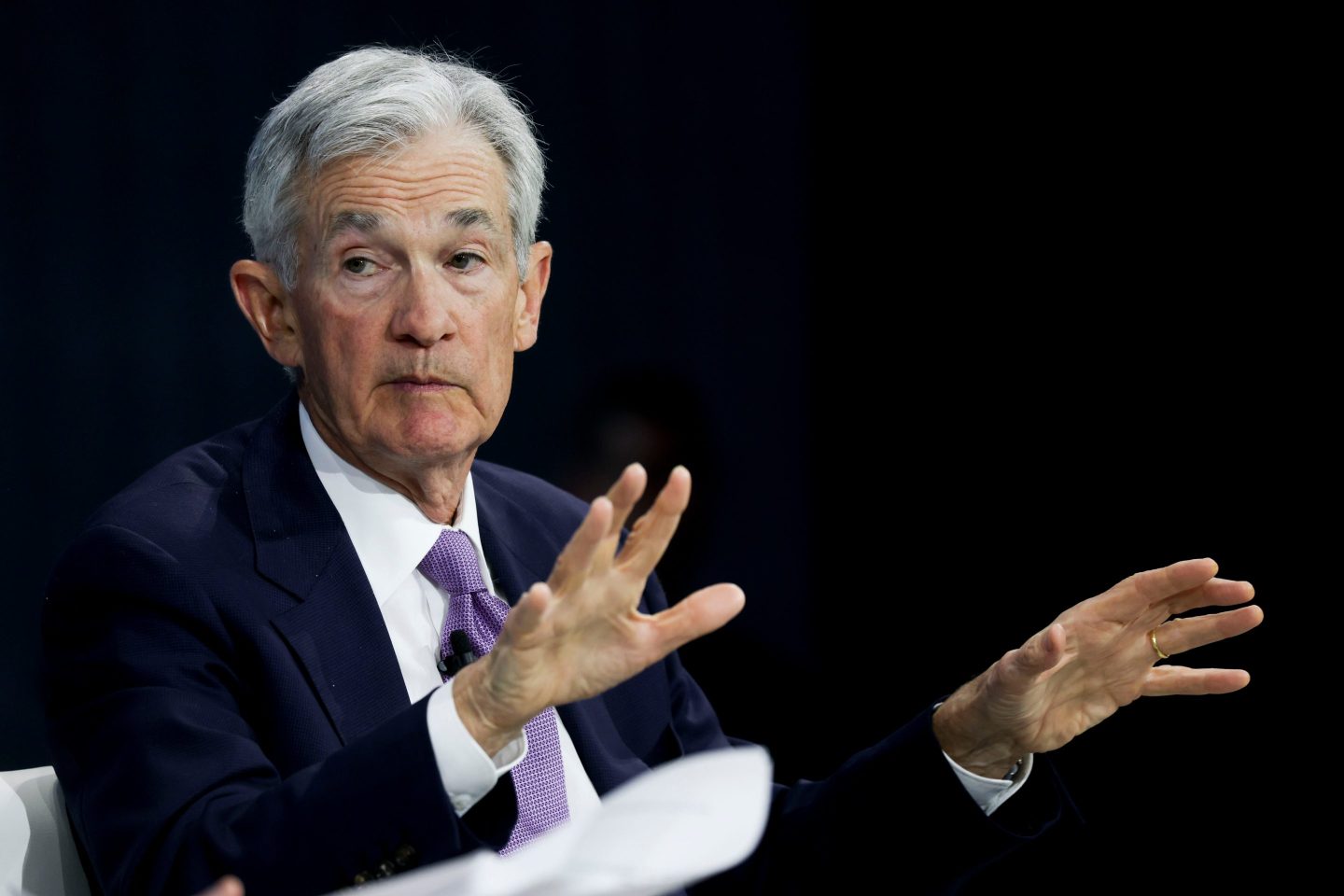 Jay Powell holds up his hands while sitting in a 1:1 discussion at the NYT Dealbook Summit