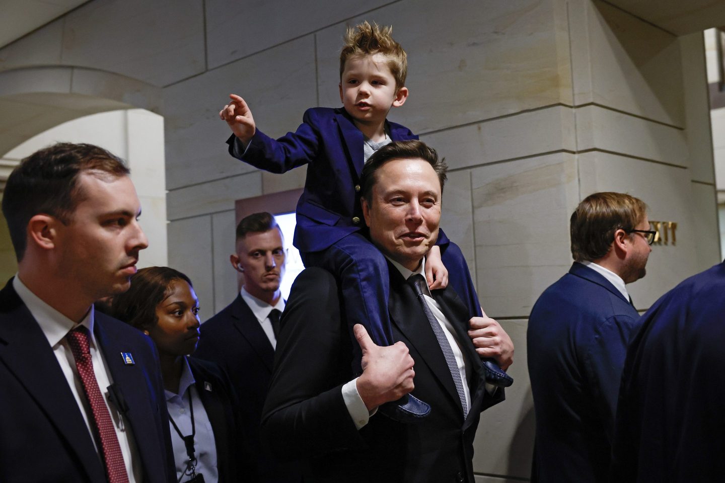 WASHINGTON, DC - DECEMBER 05: Tesla CEO Elon Musk, Co-Chair of the newly announced Department of Government Efficiency (DOGE) arrives with his son "X" on his shoulders at the U.S. Capitol before a meeting with members of the U.S. Congress December 05, 2024 in Washington, DC. Musk and DOGE Co-chair Vivek Ramaswamy are meeting with members of the U.S. Congress today about DOGE, a planned presidential advisory commission with the goal of cutting government spending and increasing efficiency in the federal workforce. (Photo by Anna Moneymaker/Getty Images)