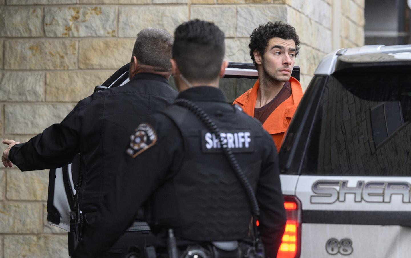 Suspected shooter Luigi Mangione is led into the Blair County Courthouse for an extradition hearing December 10, 2024 in Hollidaysburg, Pennsylvania