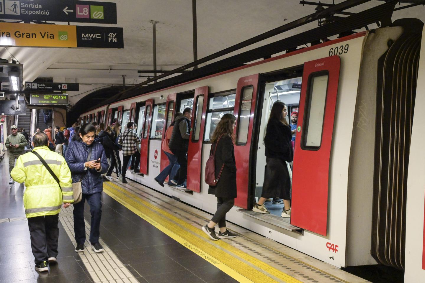 People in Barcelona board the subway train