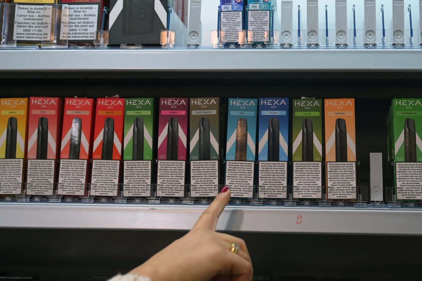 A saleswoman shows disposable electronic cigarettes in her shop in Brussels.