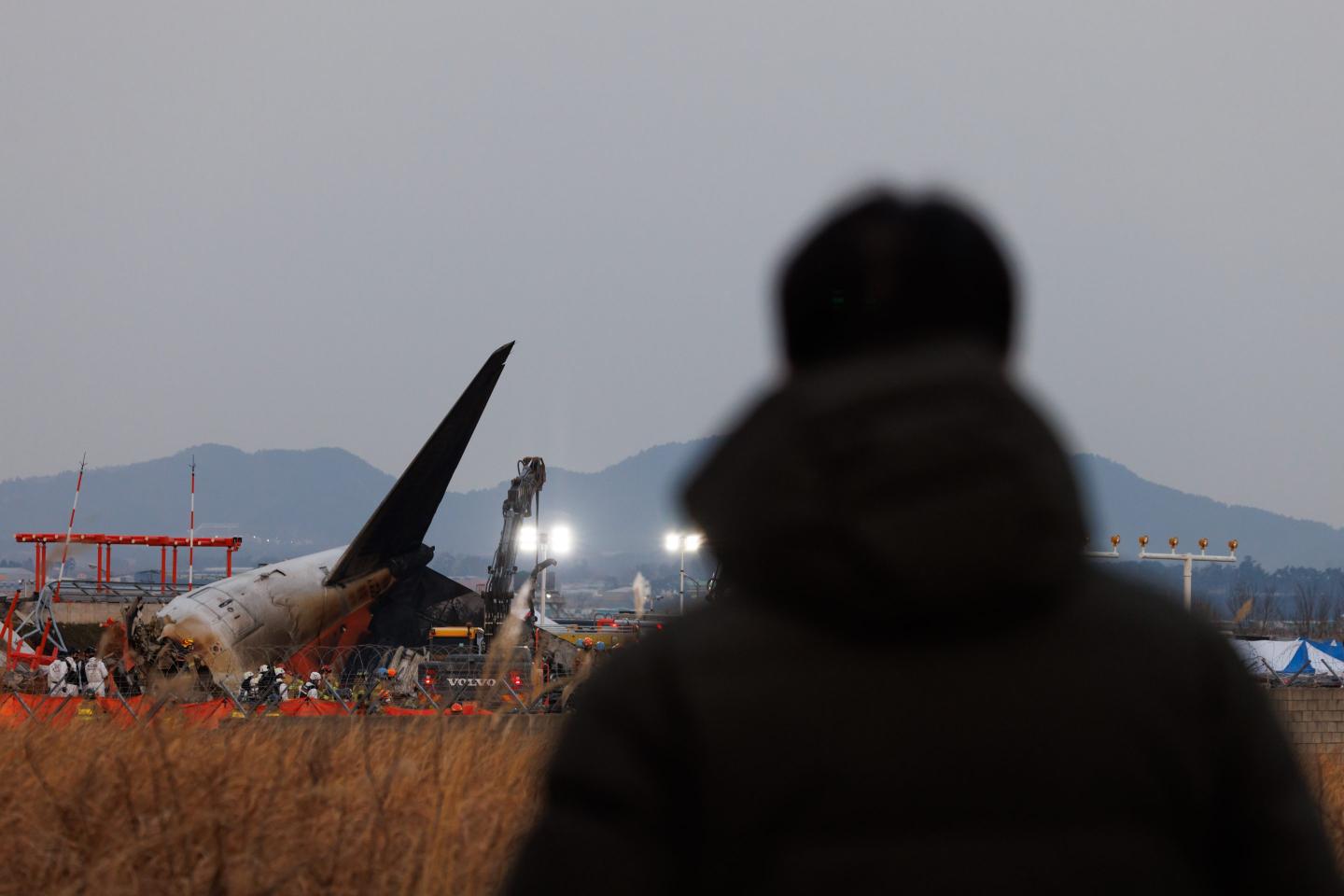 The tail of Jeju Air plane at the site of a plane fire at Muan International Airport in Muan County, South Korea, on Sunday