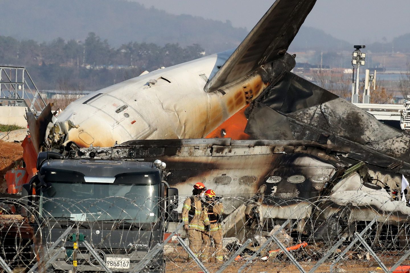 Firefighters and rescue teams work at the wreckage of Jeju Air Flight 7C2216 in Muan-gun, South Korea, on Sunday.