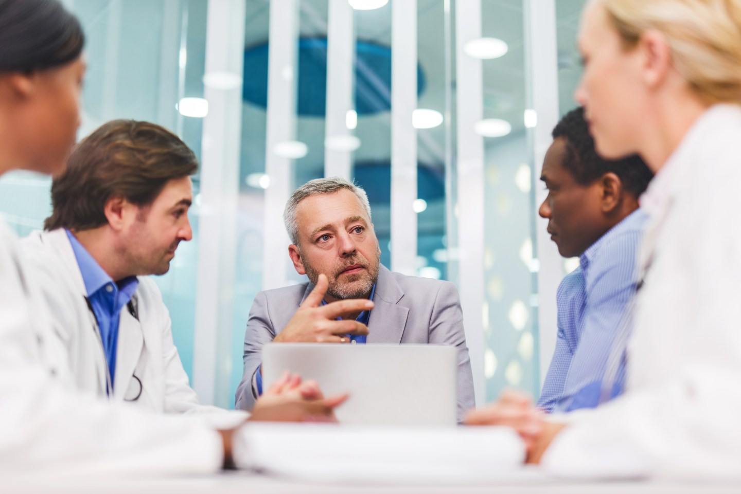 Businessman conversing with doctors in the hospital
