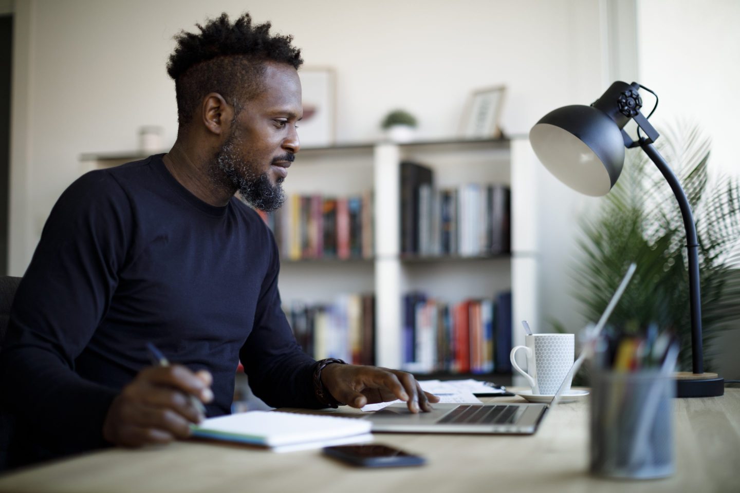 Smiling man working at home.