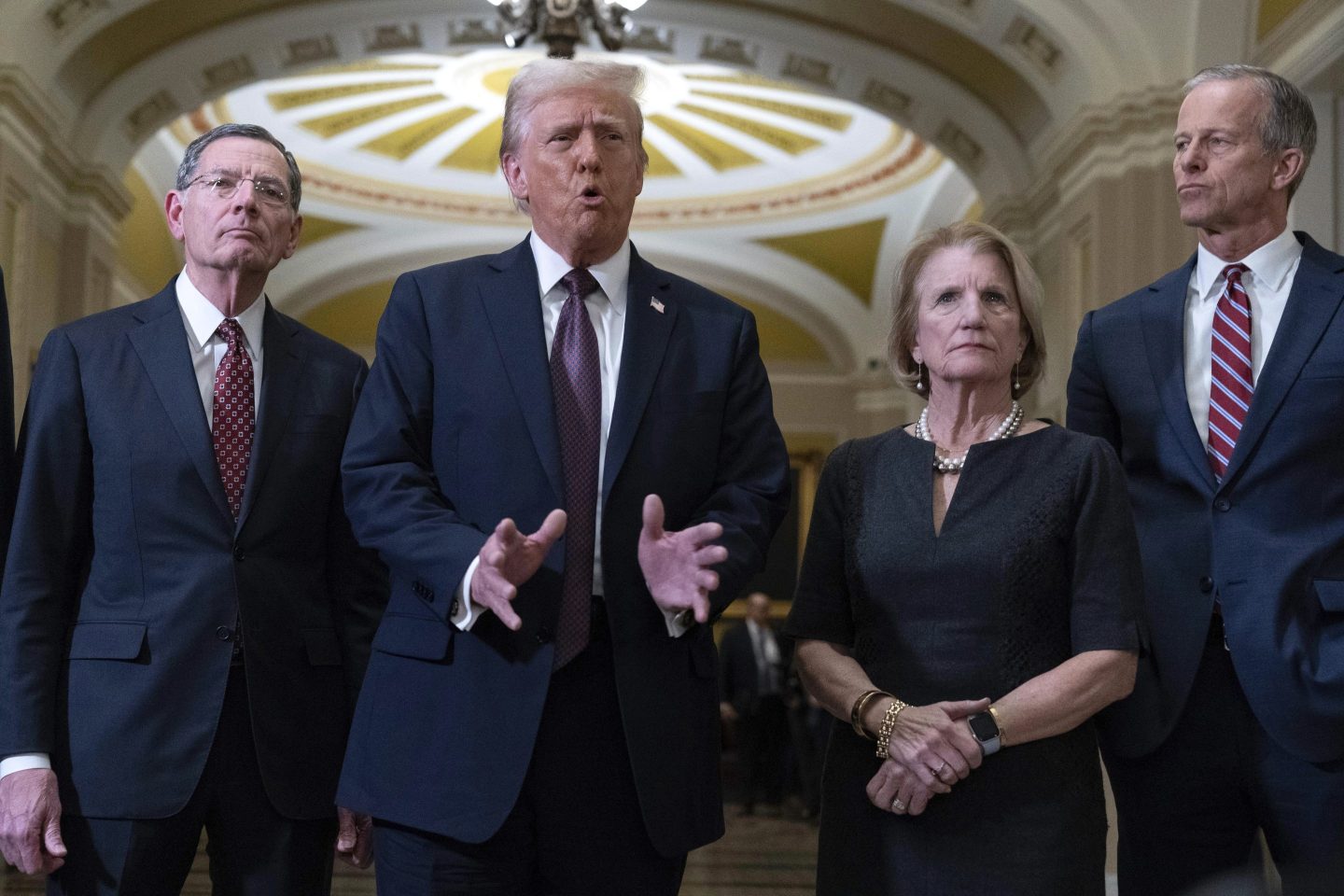 President-elect Donald Trump flanked by Sen. John Barrasso, R-Wyo., left, Sen. Shelley Moore Capito, R-W.Va., and Senate Majority Leader John Thune of S.D. talks to reporters after a meeting with Republican leadership at the Capitol on Jan. 8, 2025, in Washington.