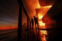 Los Angeles wildfires have already destroyed almost 2,000 homes and other buildings and forced 130,000 people to evacuate