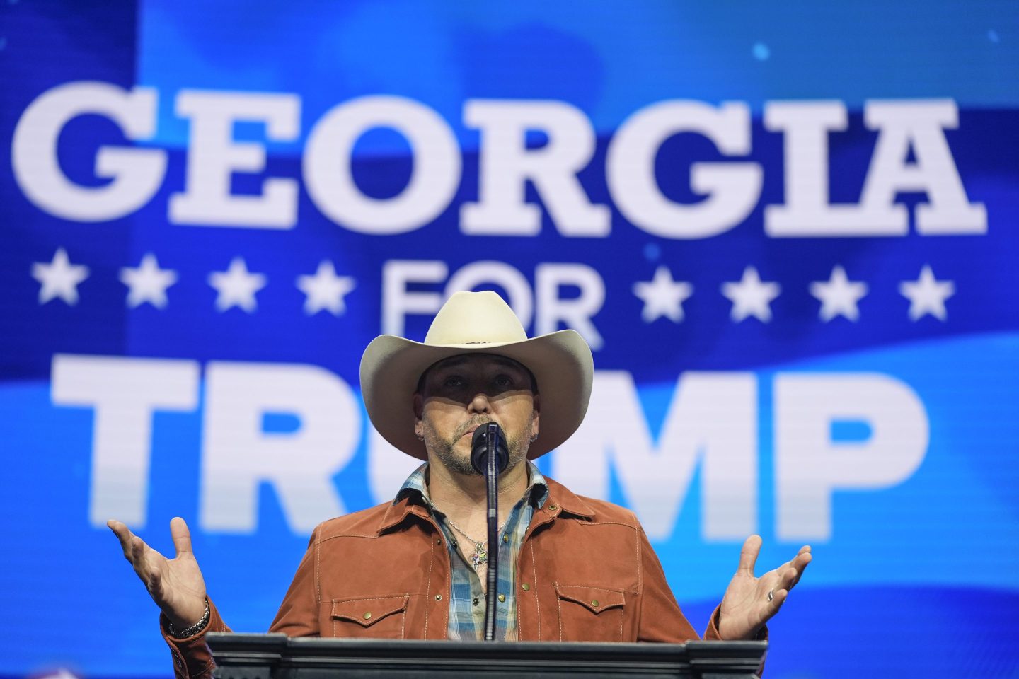 Jason Aldean stands on stage at a Trump rally in Georgia