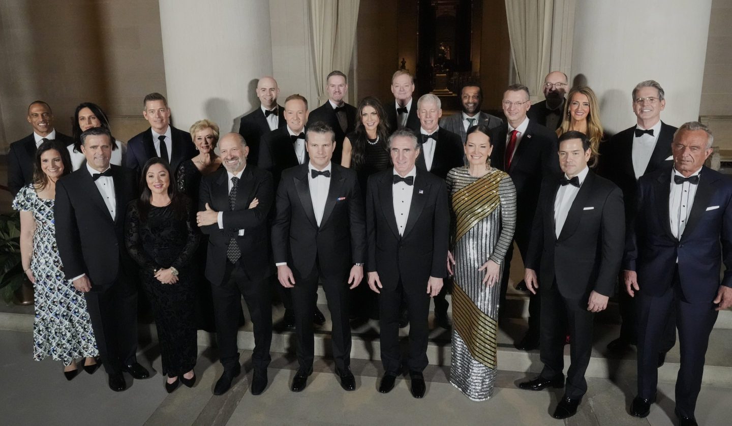 Trump's wealthy Cabinet picks pose for the camera wearing suits and dresses