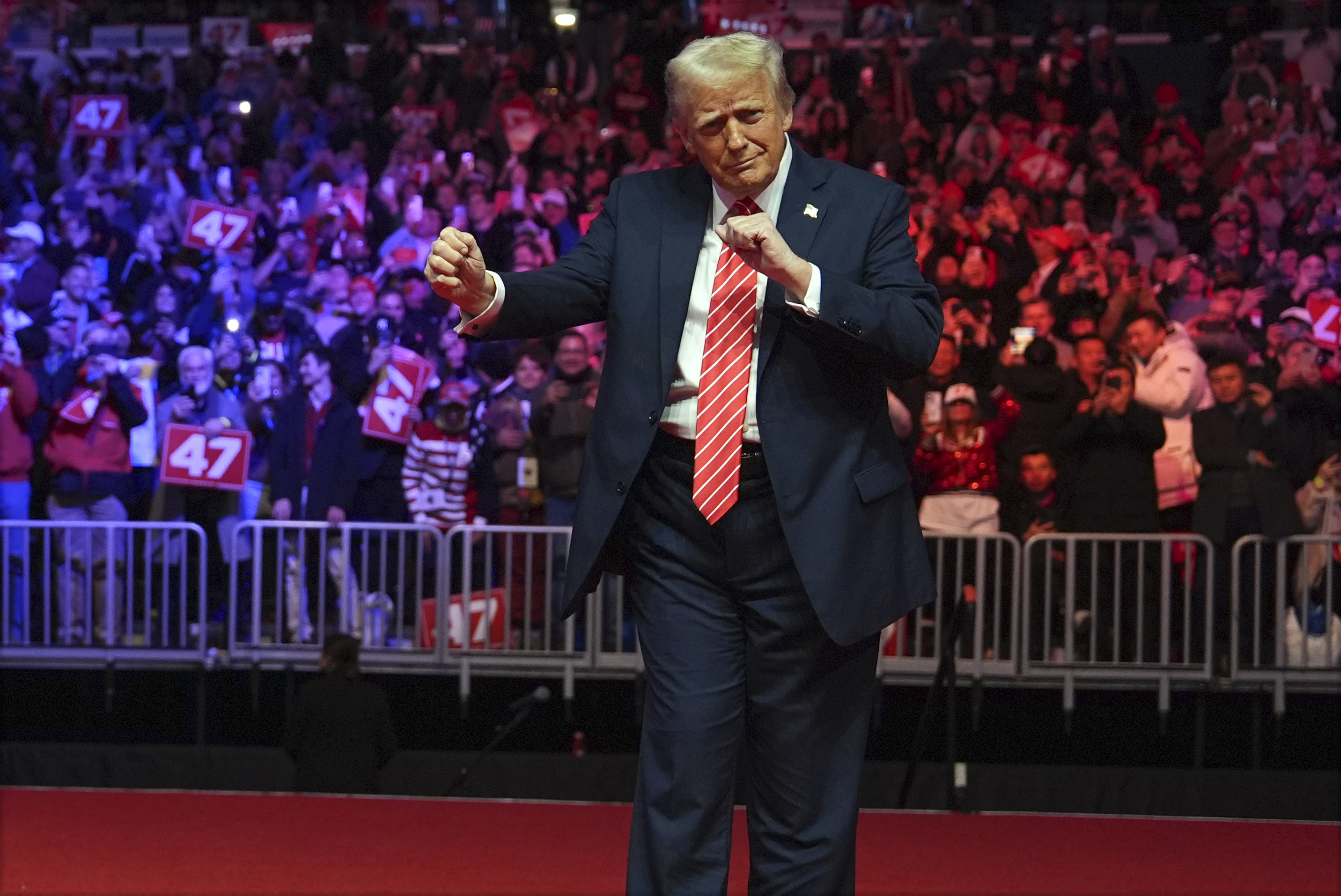 President-elect Donald Trump dances with The Village People at a rally ahead of the 60th Presidential Inauguration, on Jan. 19, 2025, in Washington. 