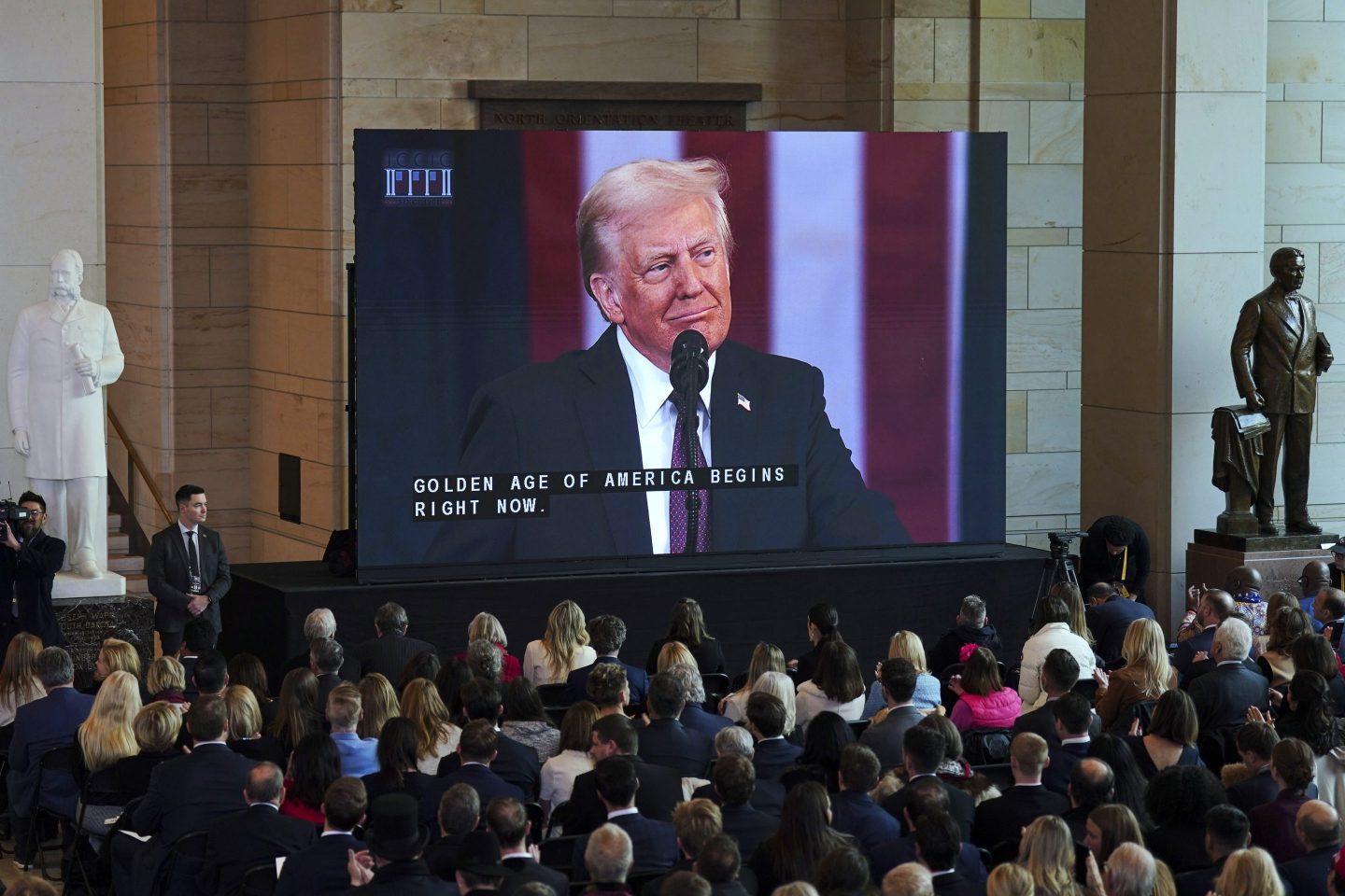 People watch the 60th Presidential Inauguration from Emancipation Hall, on Jan. 20, 2025, at the U.S. Capitol in Washington.